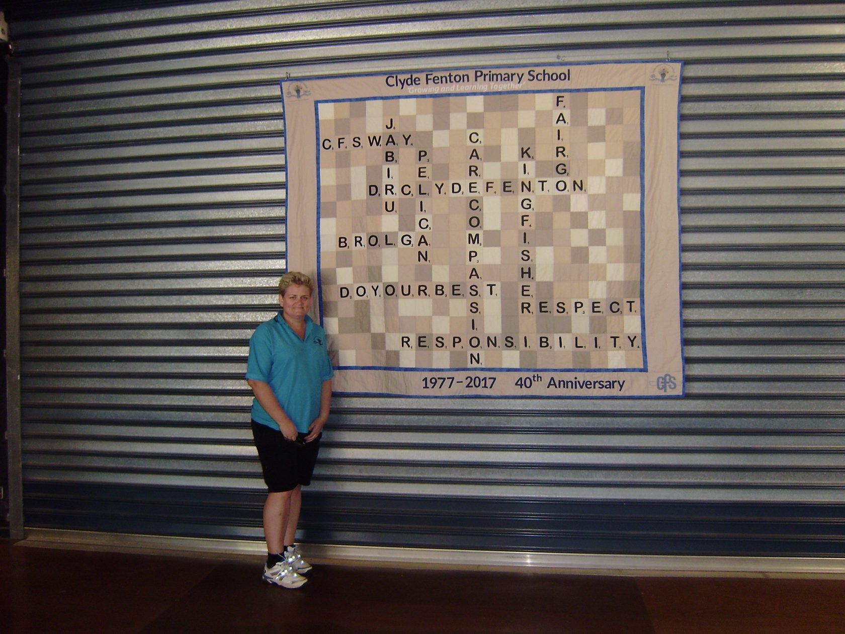 A woman stands in front of a large chess board