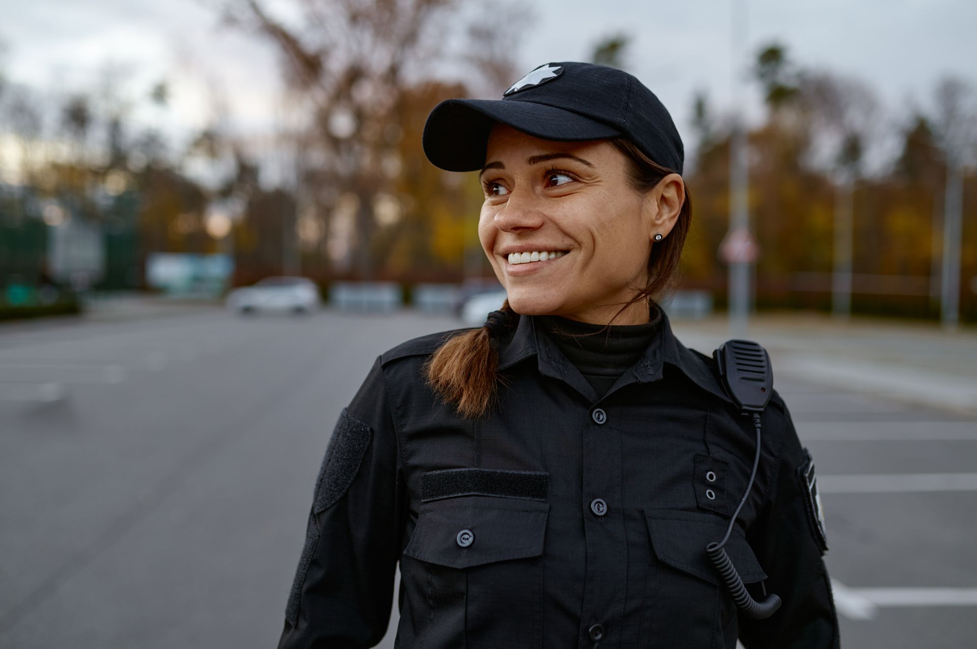 Smiling security officer in uniform on duty outdoors