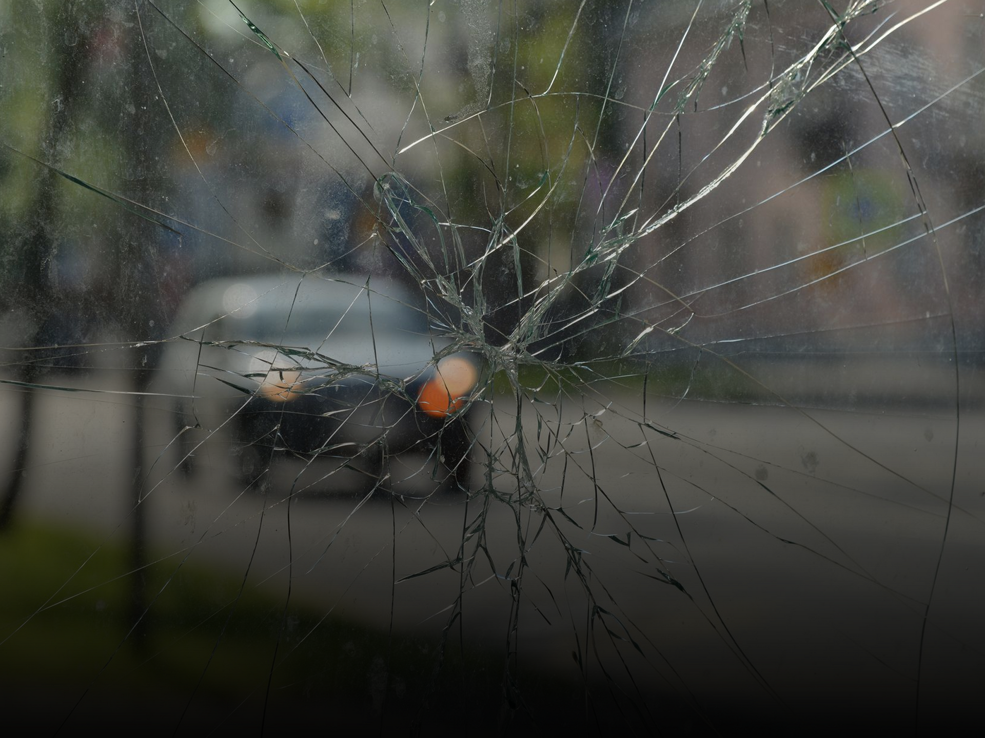 Cracked windshield close-up showing need for professional auto glass repair service.