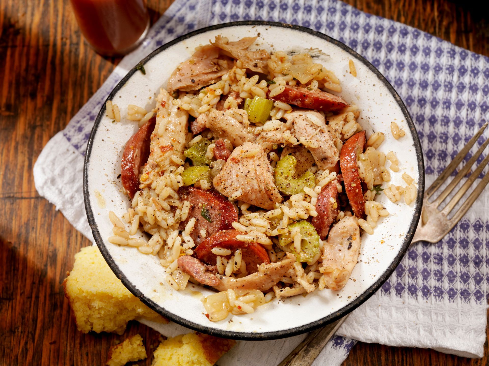 Chicken and sausage jambalaya with cornbread on a plate.