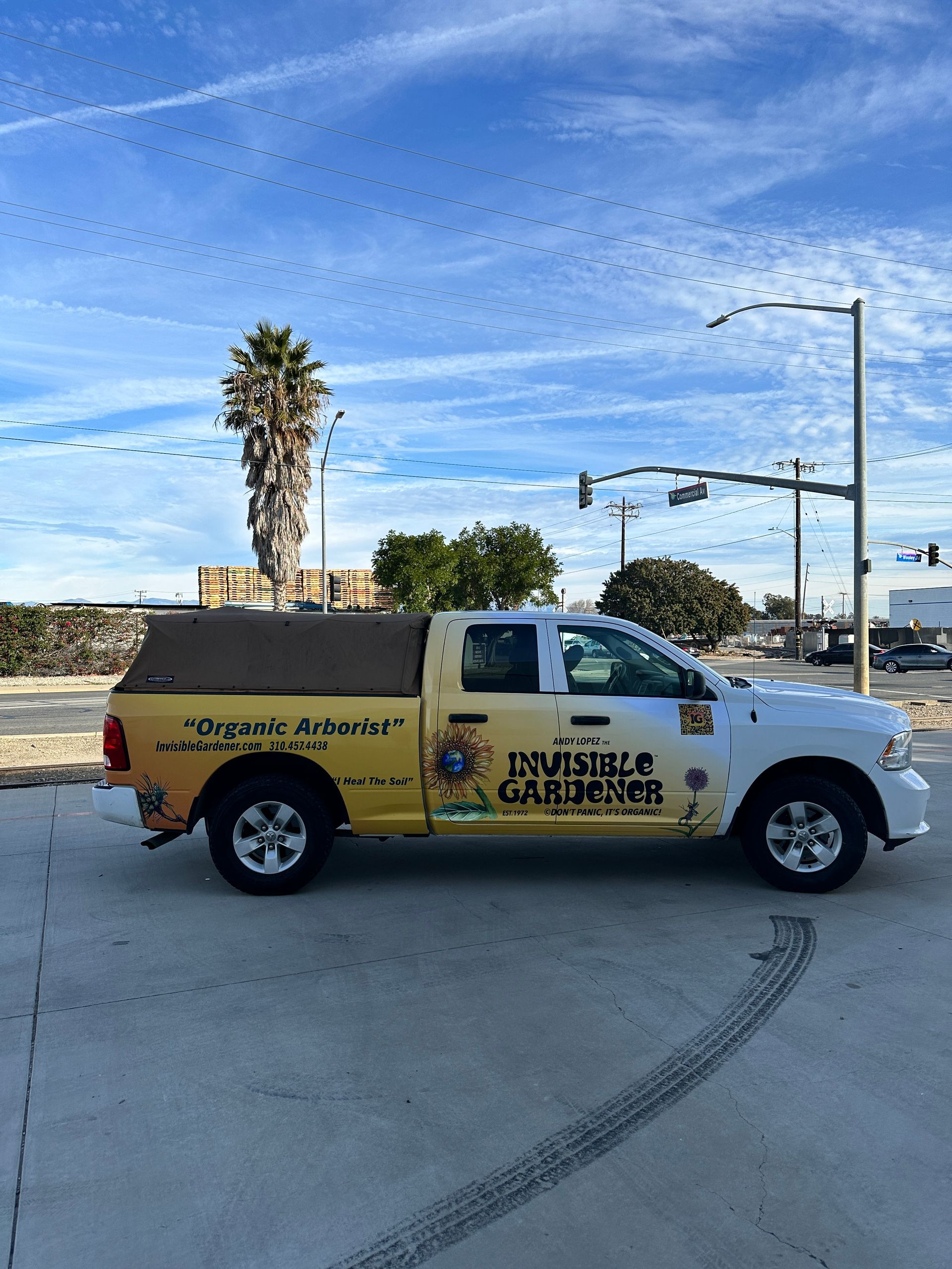 A yellow and white truck is parked on the side of the road.