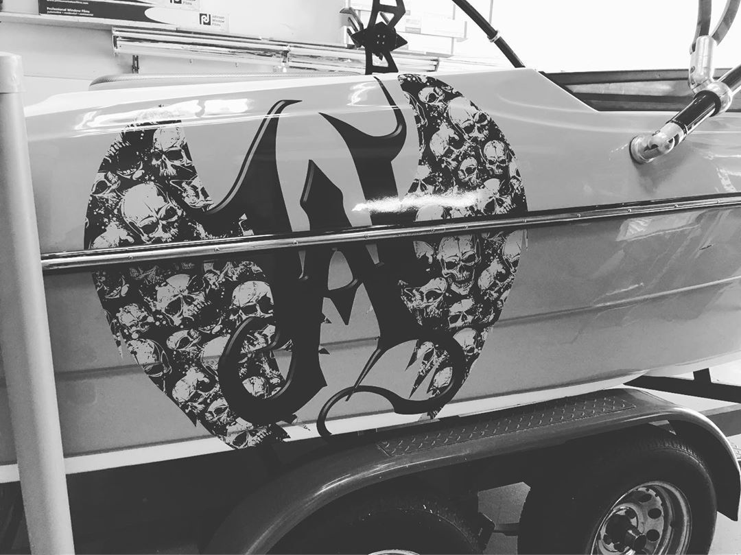 A black and white photo of a boat with skulls on it