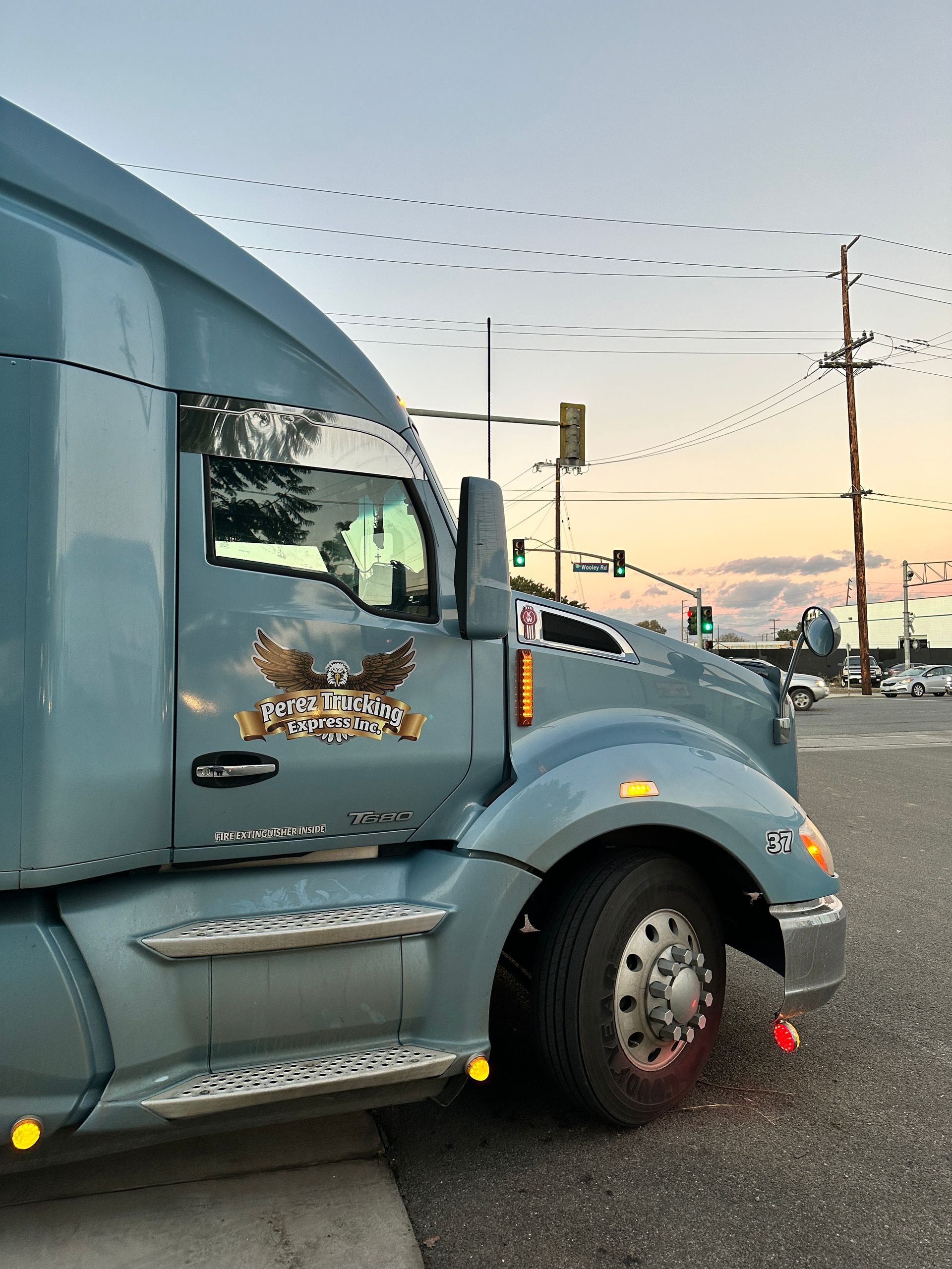 A semi truck is parked on the side of the road.