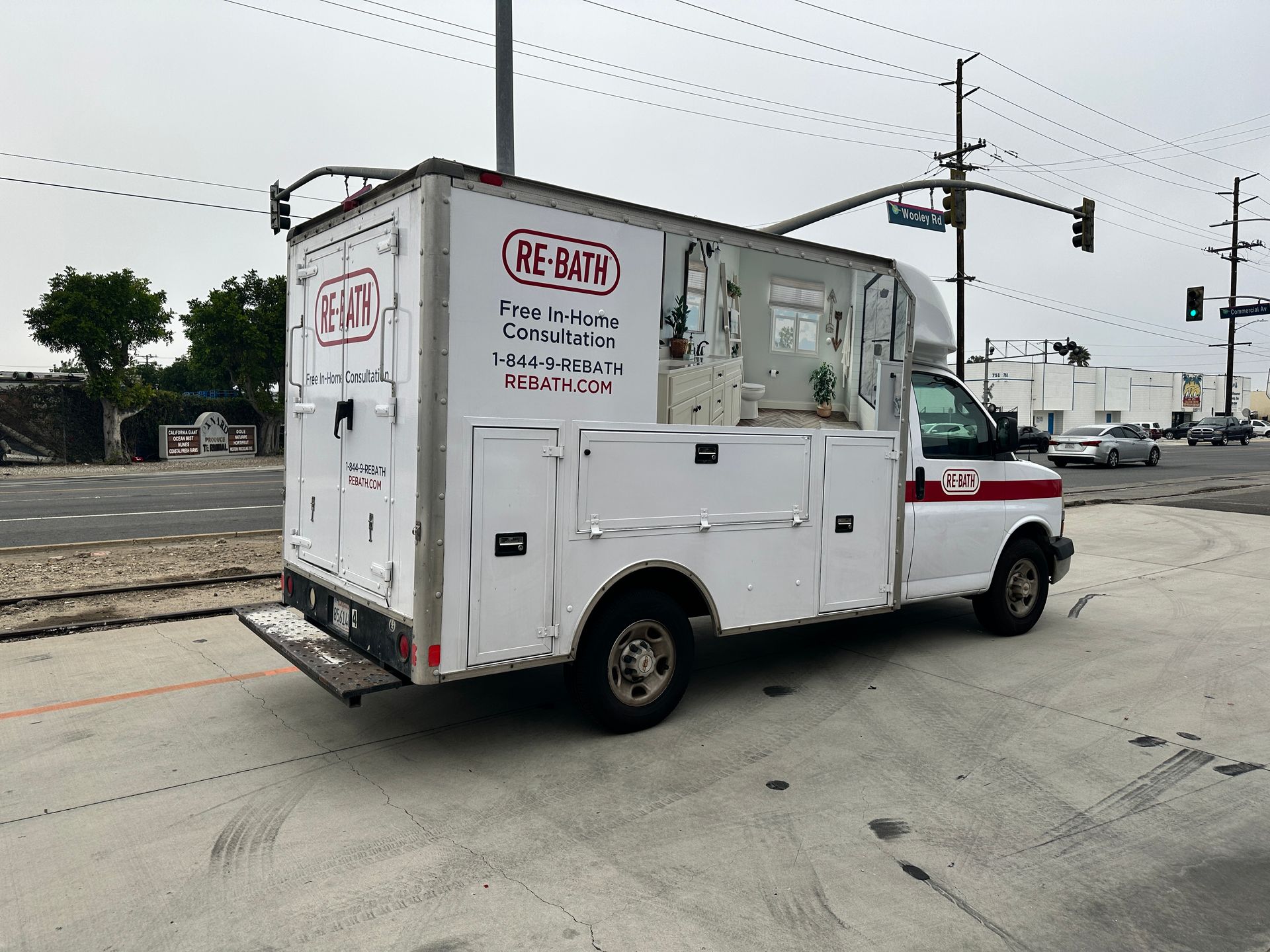 A white utility truck is parked on the side of the road.