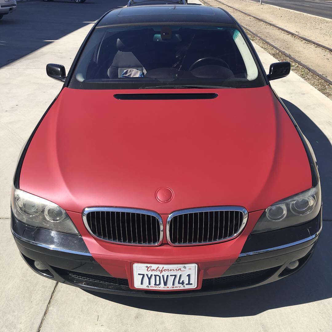 A red car with a license plate that says 7ydv741