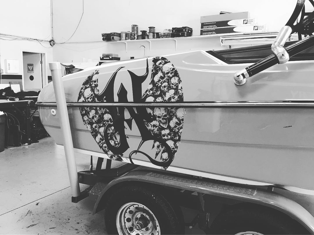 A black and white photo of a boat with a skull design on the side.