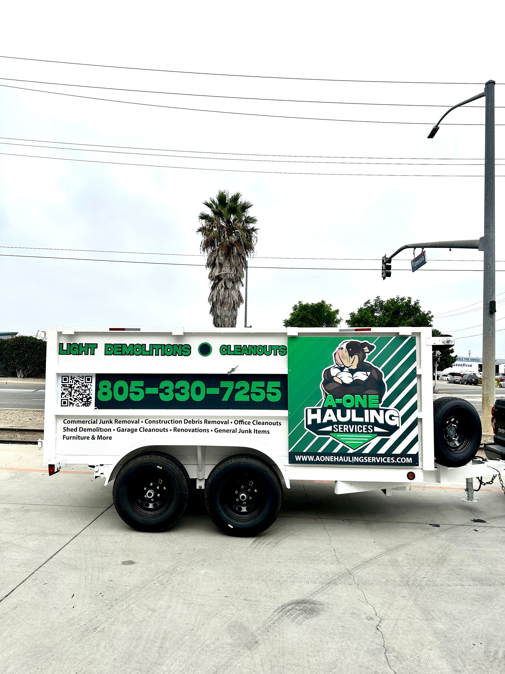A trailer is parked on the side of the road in a parking lot.