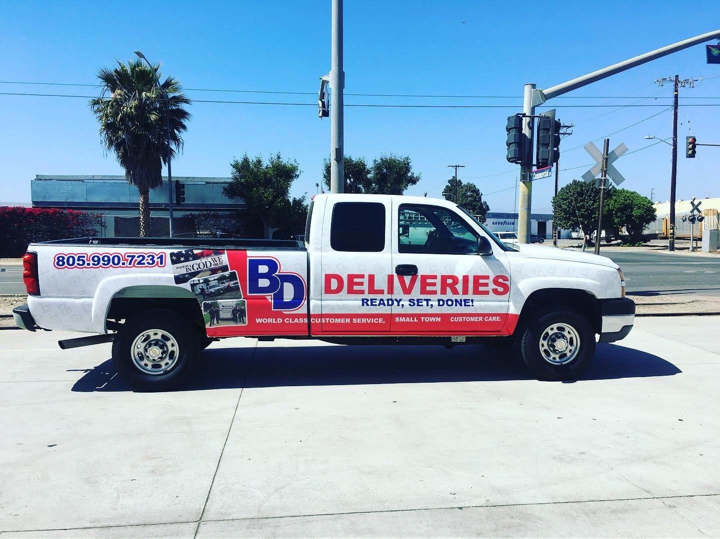 A bd delivery truck is parked on the side of the road