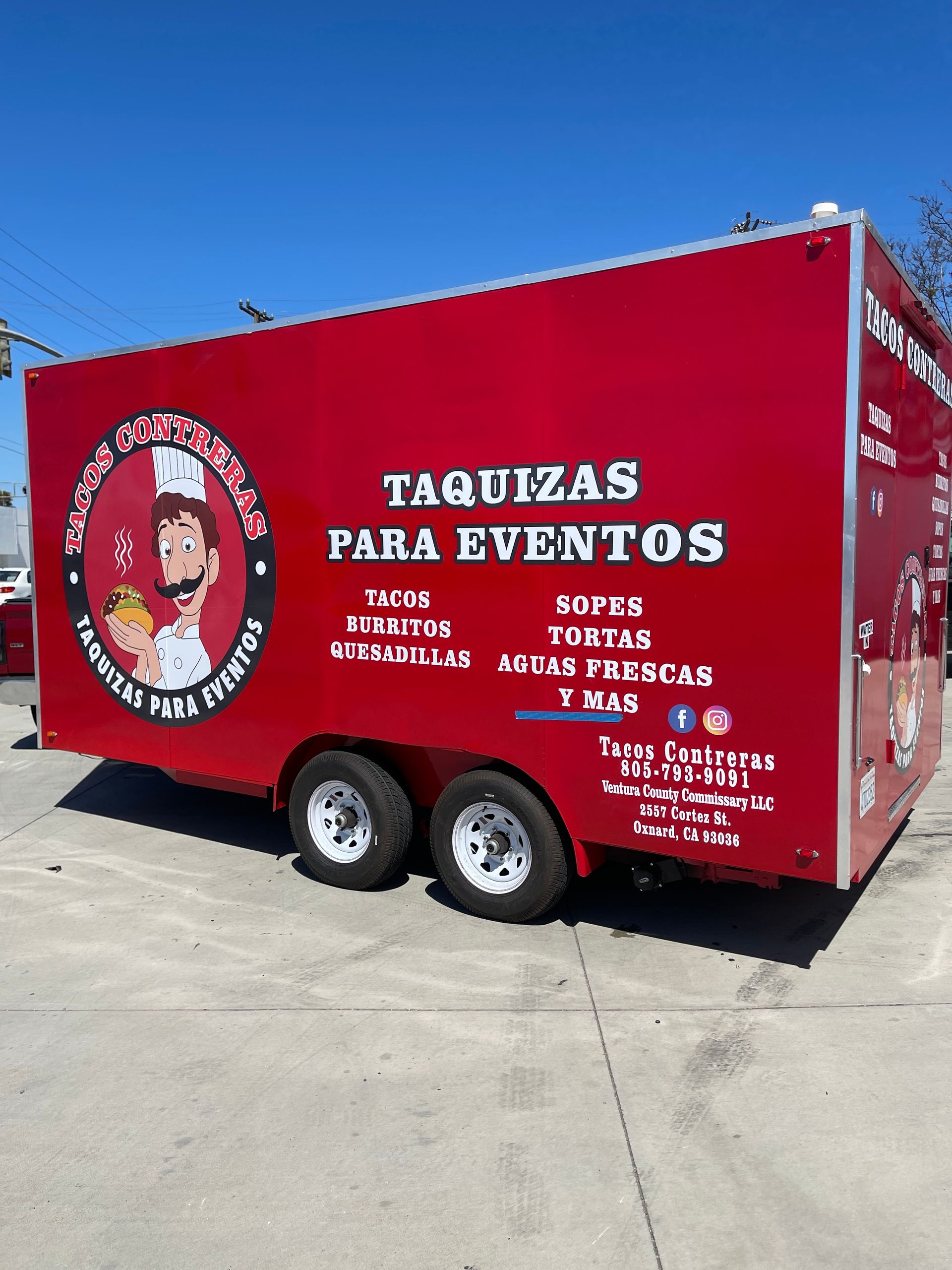 A red taquizas para eventos food truck is parked in a parking lot