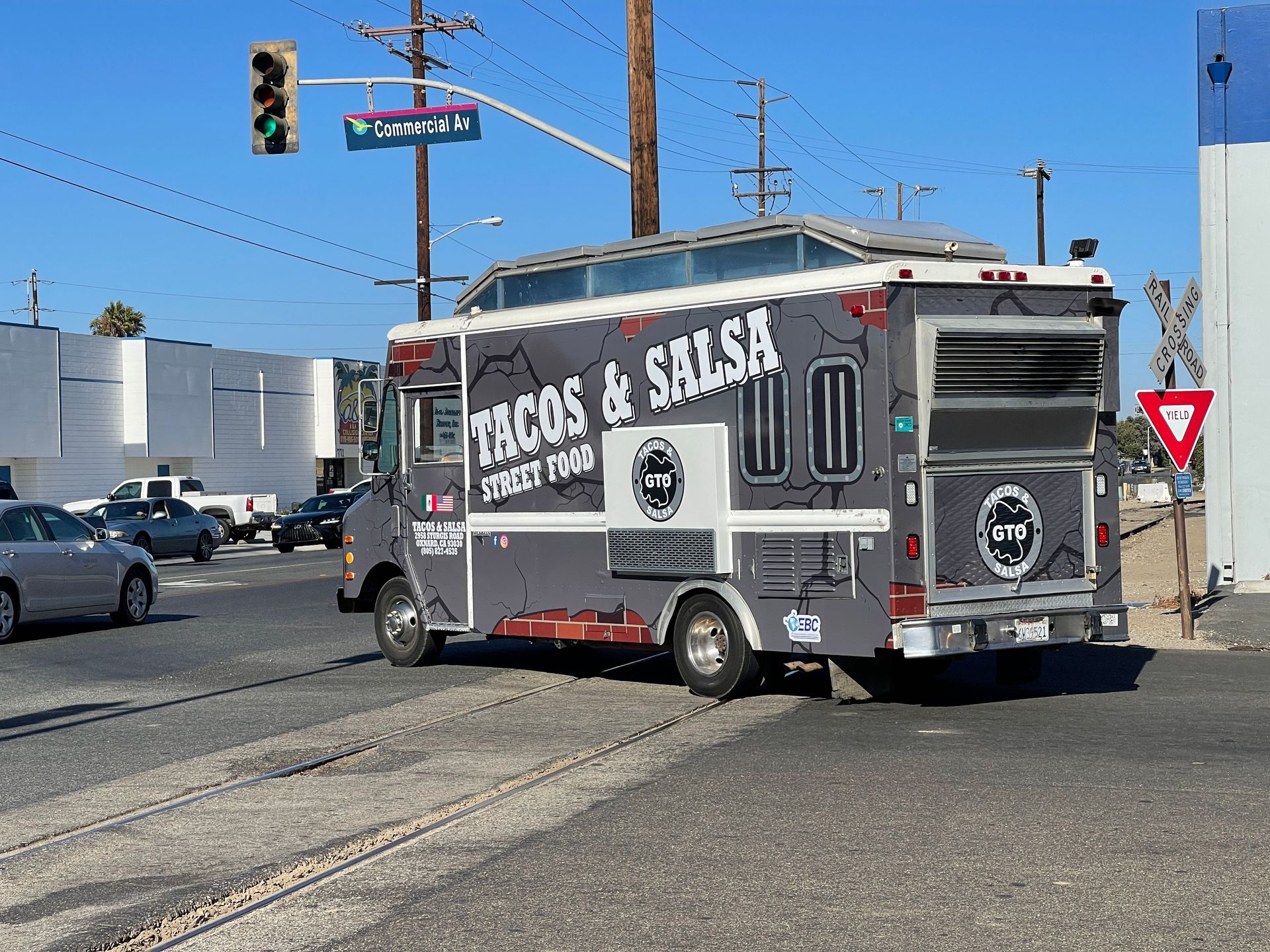 A tacos and salsa food truck is parked on the side of the road.