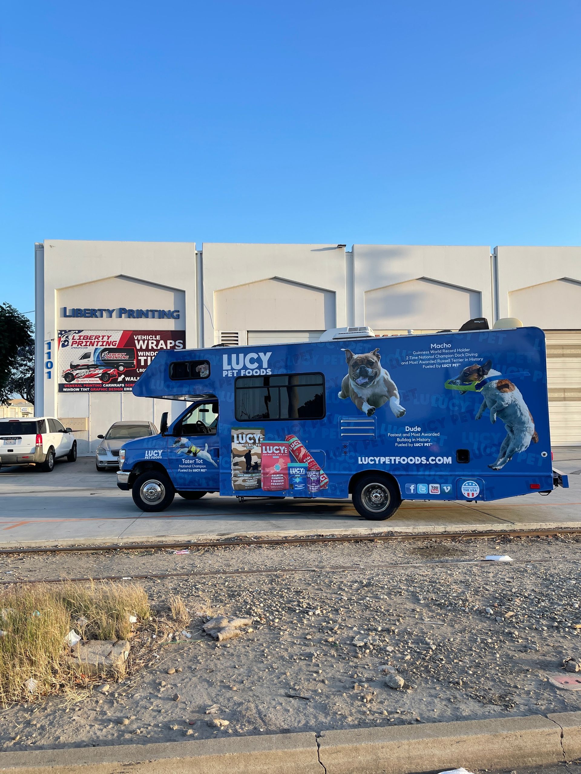 A blue rv is parked on the side of the road