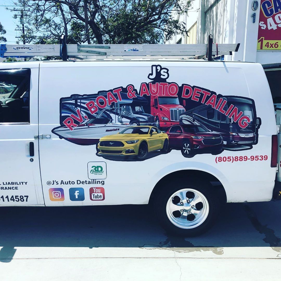 A white van with a sticker on the side that says j 's auto detailing