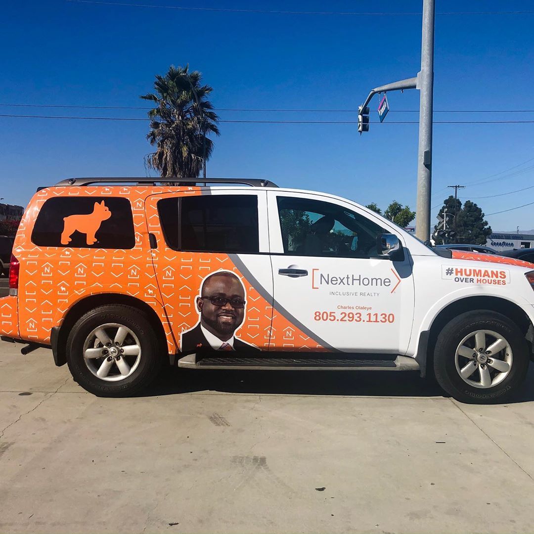 A white suv with a picture of a man and a dog on it