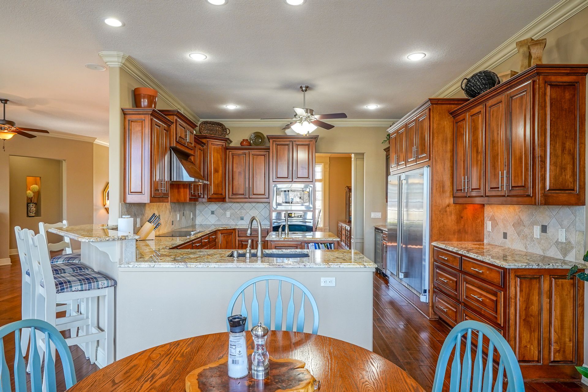 A kitchen with a table and chairs in it