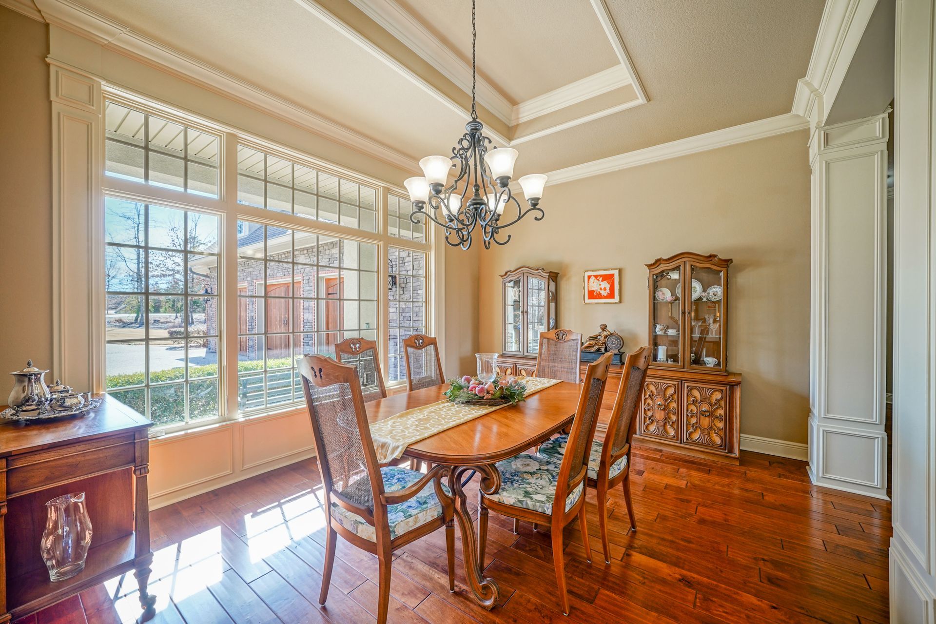 A dining room with a table and chairs and a chandelier.