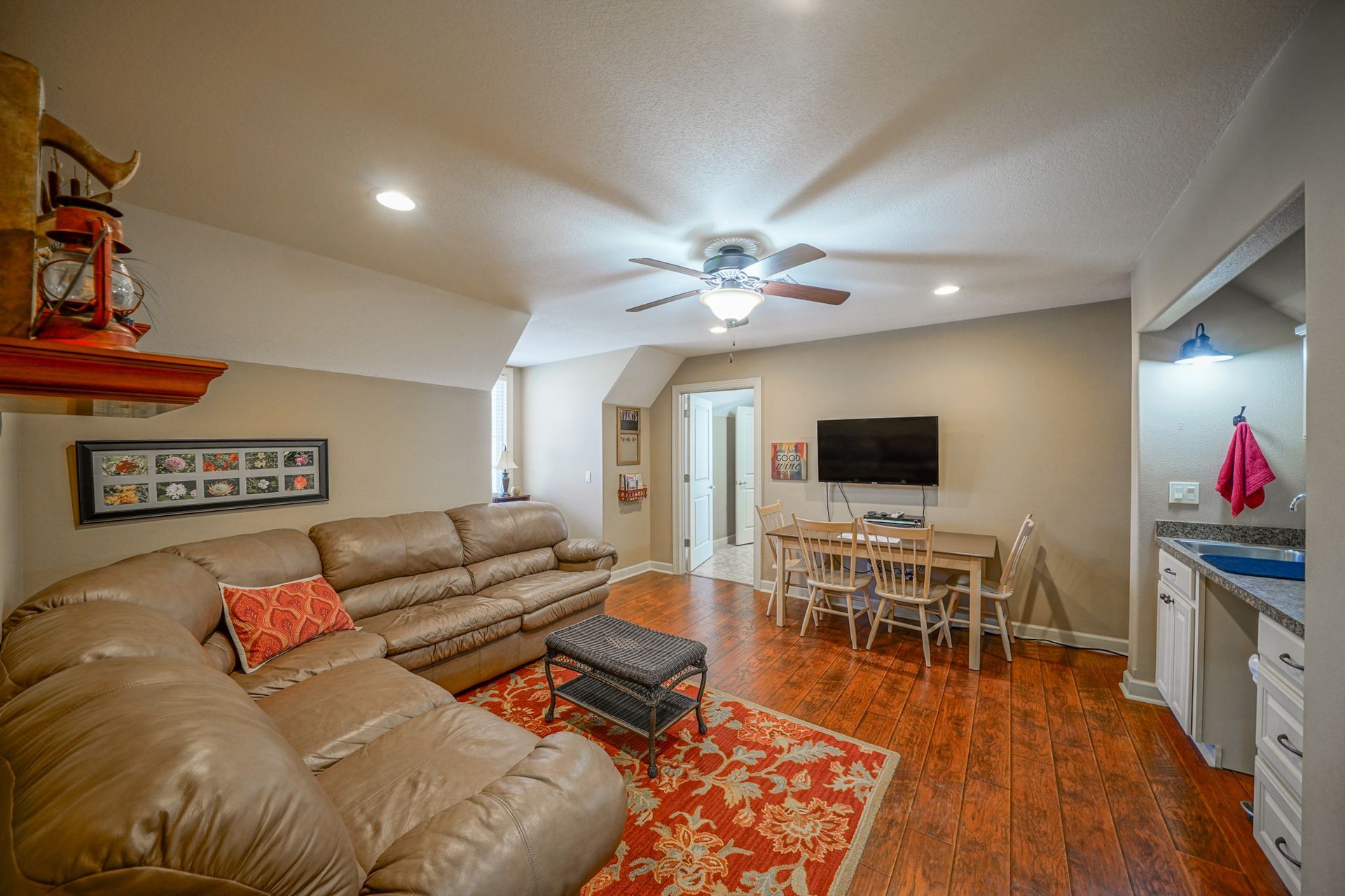A living room with a couch , table and television.