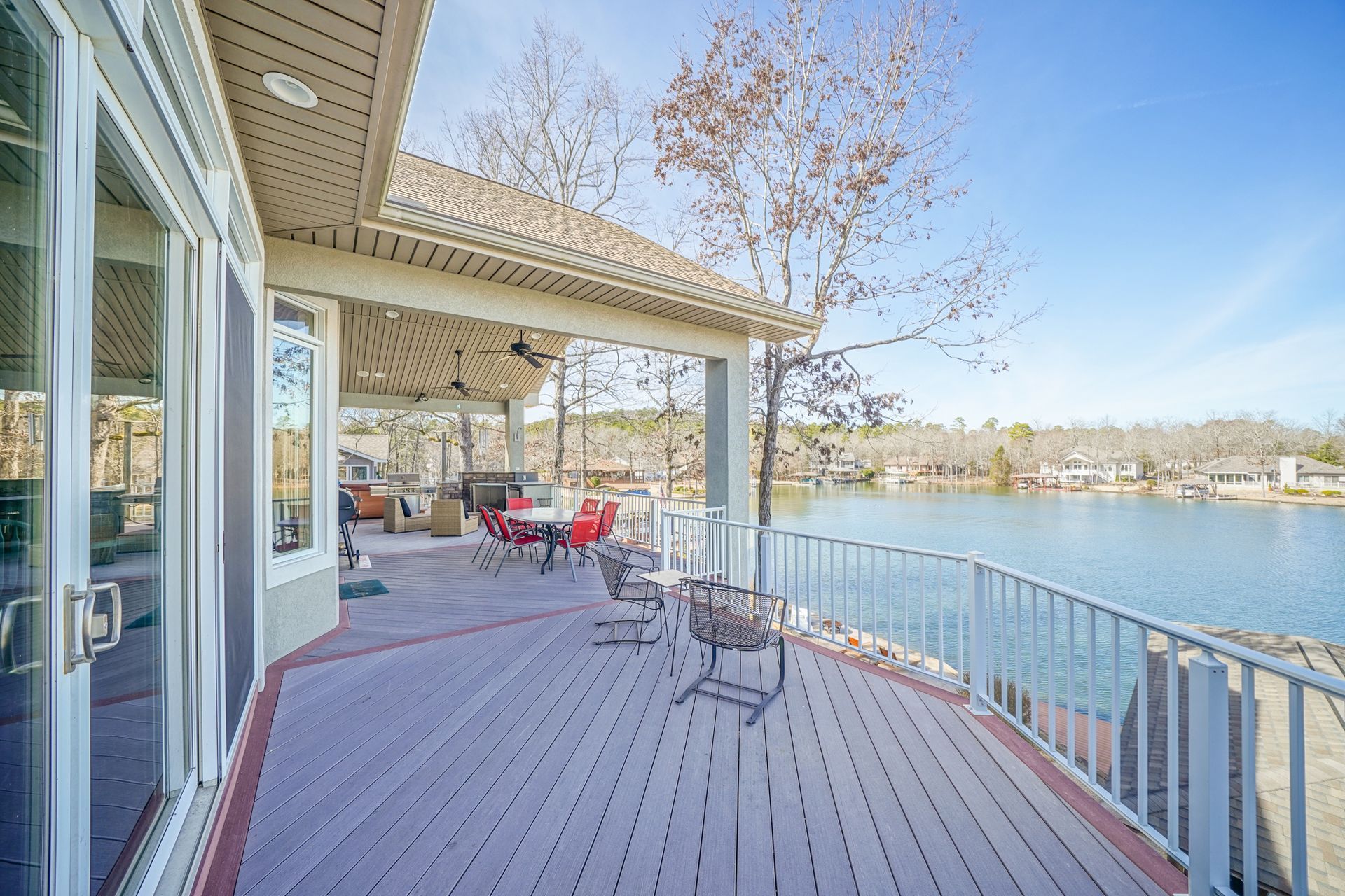 There is a large deck with a view of a lake.