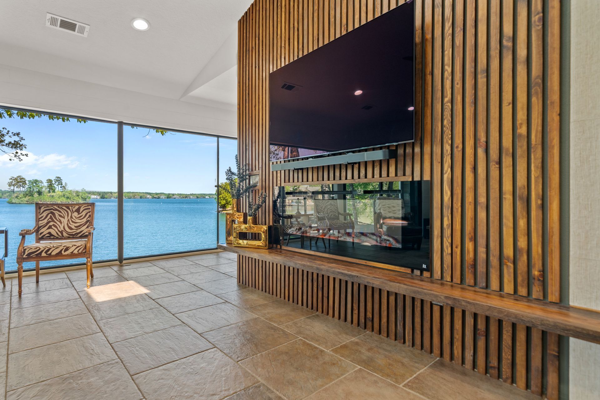 A living room with a large flat screen tv mounted on the wall.