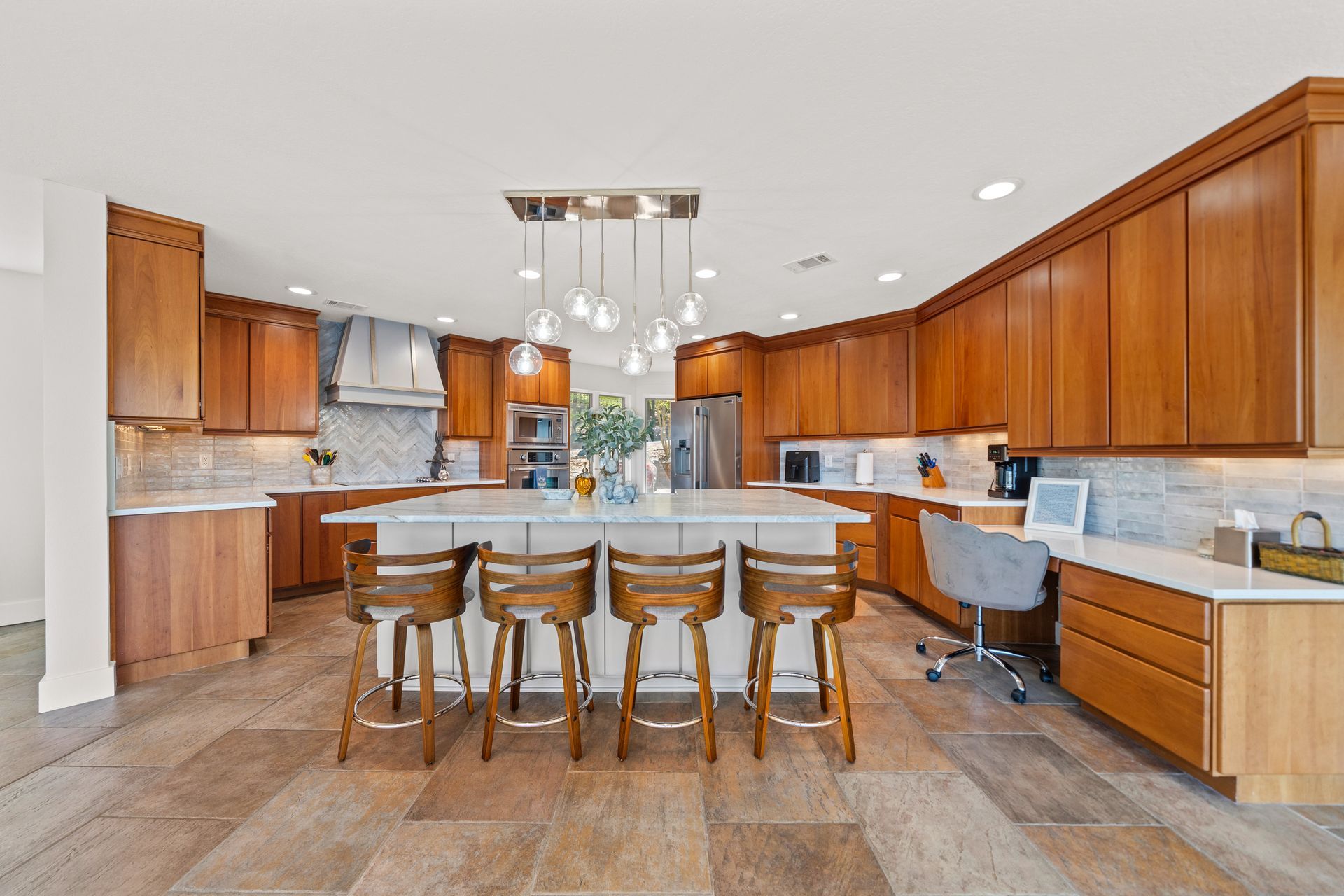 A large kitchen with wooden cabinets and a large island.