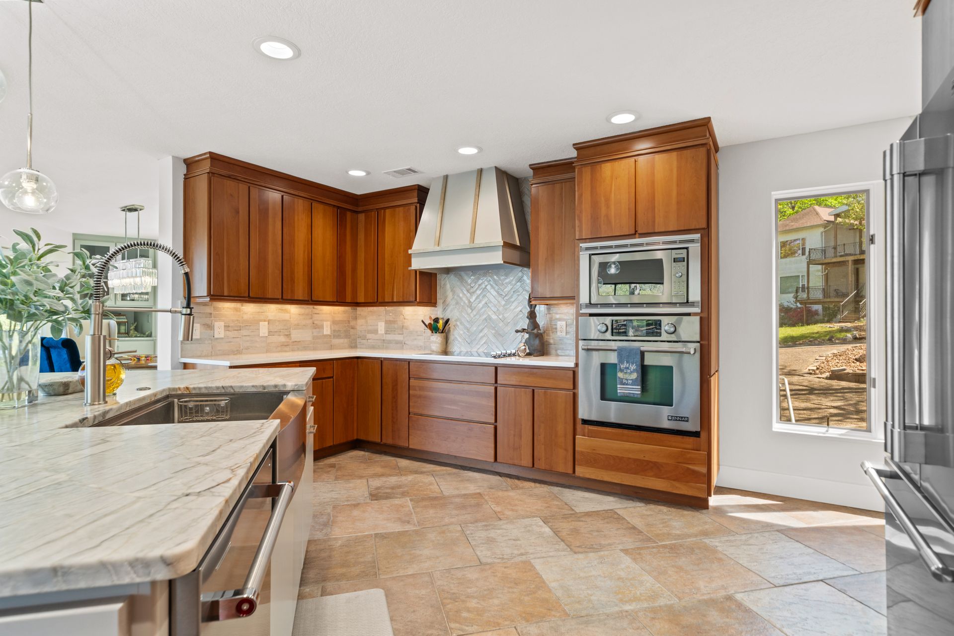 A kitchen with stainless steel appliances and wooden cabinets.