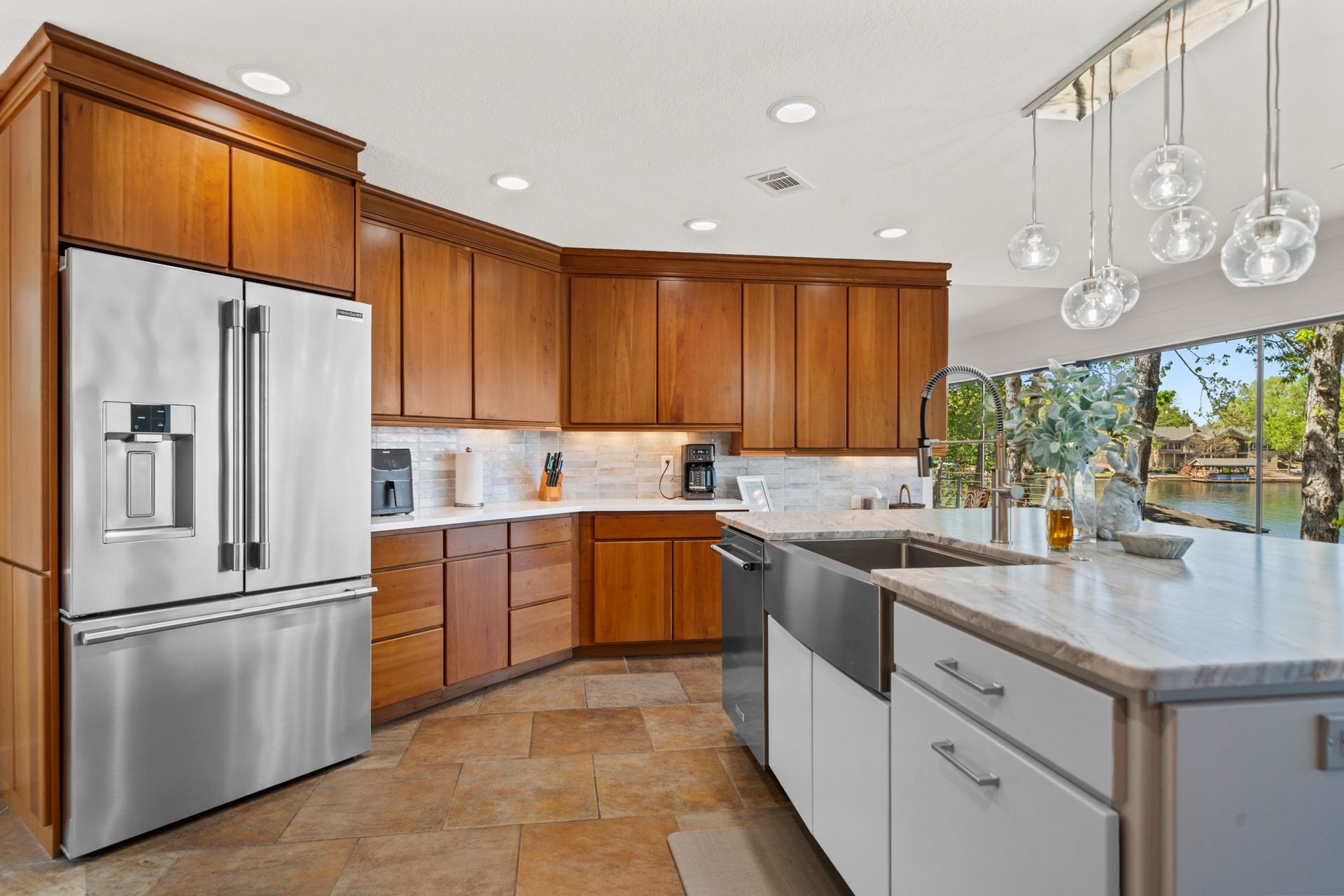 A kitchen with stainless steel appliances and wooden cabinets.