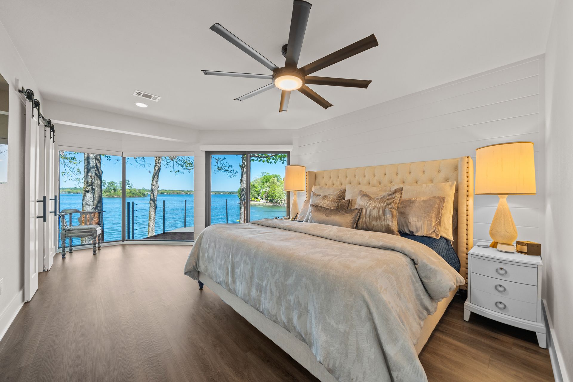 A bedroom with a large bed and a ceiling fan.
