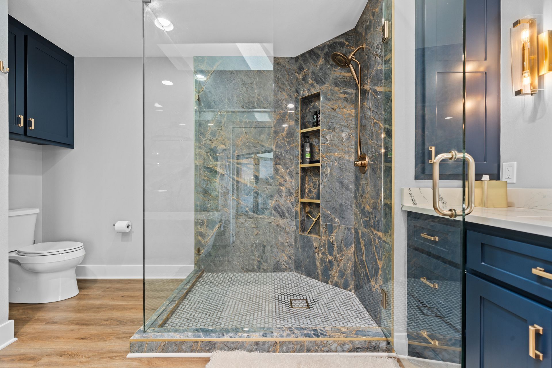 A bathroom with a walk in shower and a toilet.