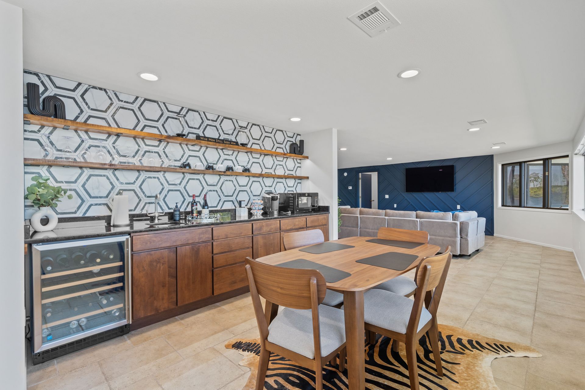 There is a dining table and chairs in the middle of the room.