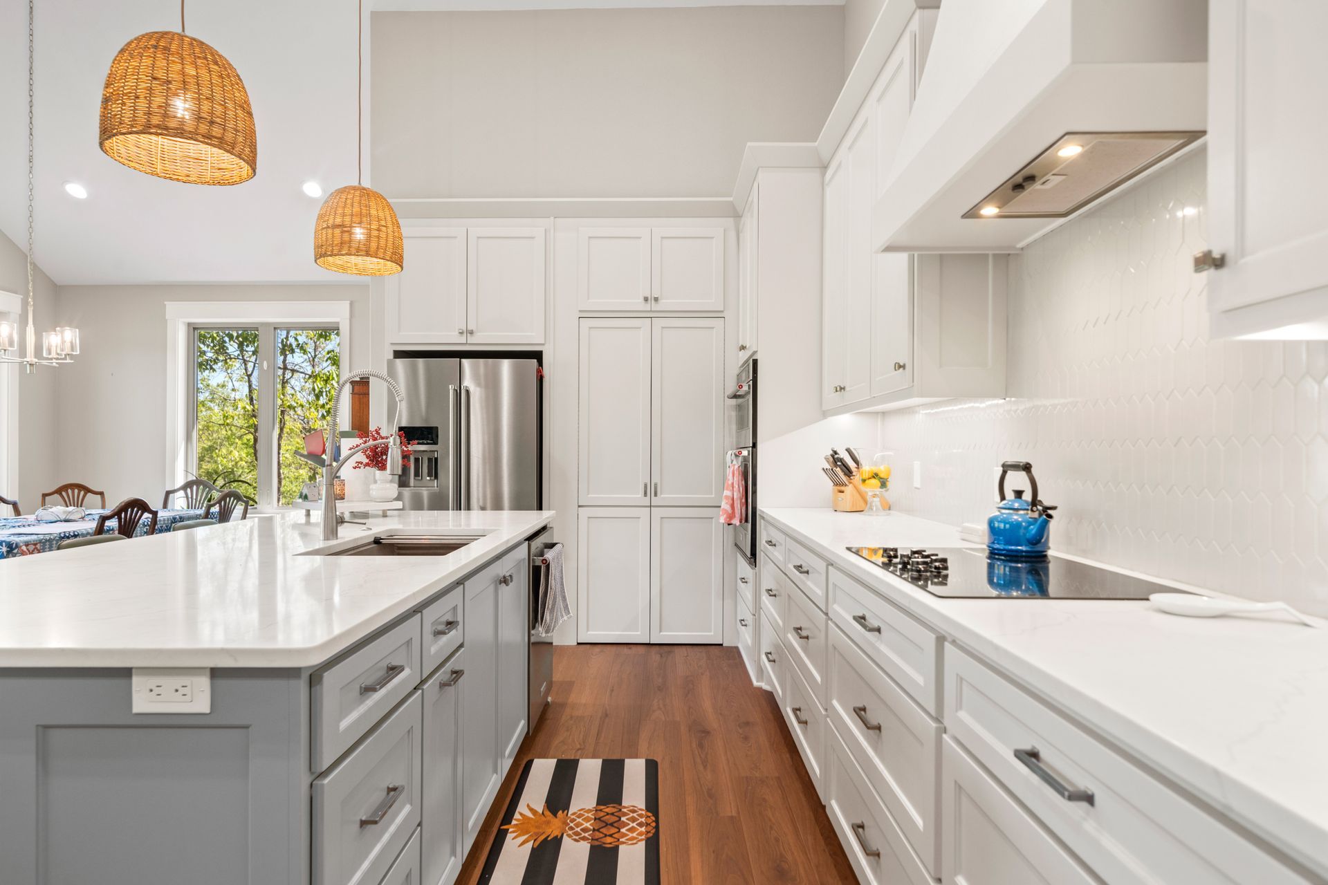 A kitchen with white cabinets and stainless steel appliances.