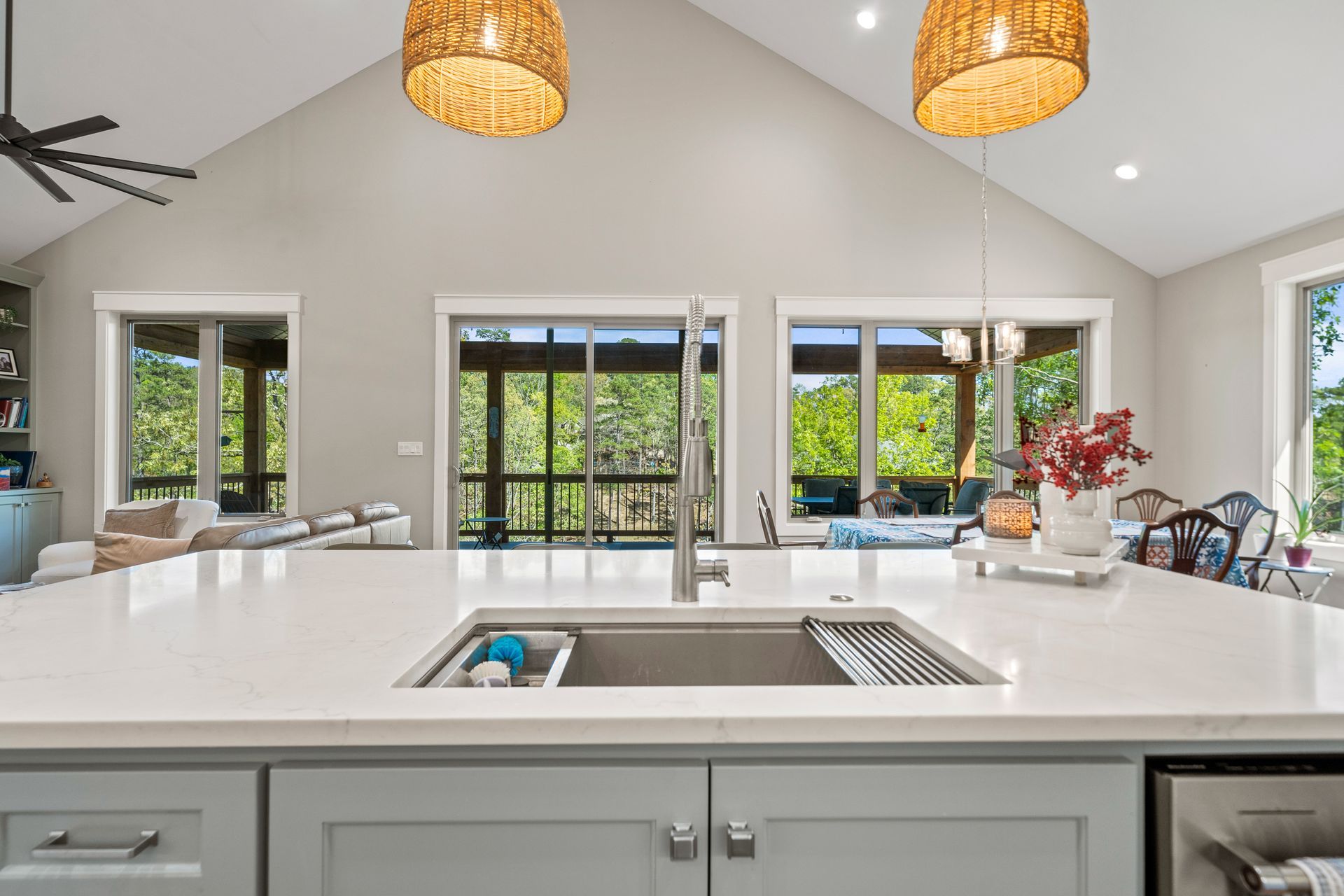 A kitchen with a sink and a lot of windows.
