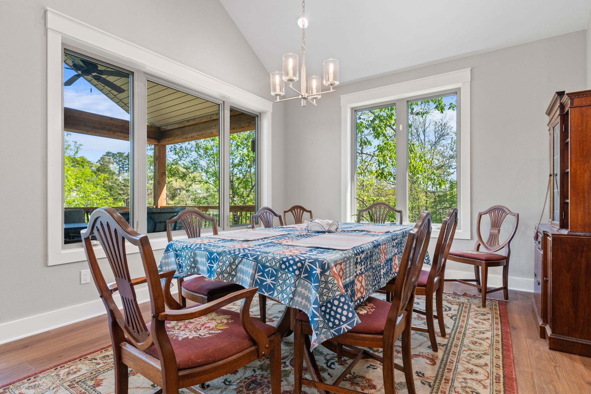 A dining room with a table and chairs and a chandelier.