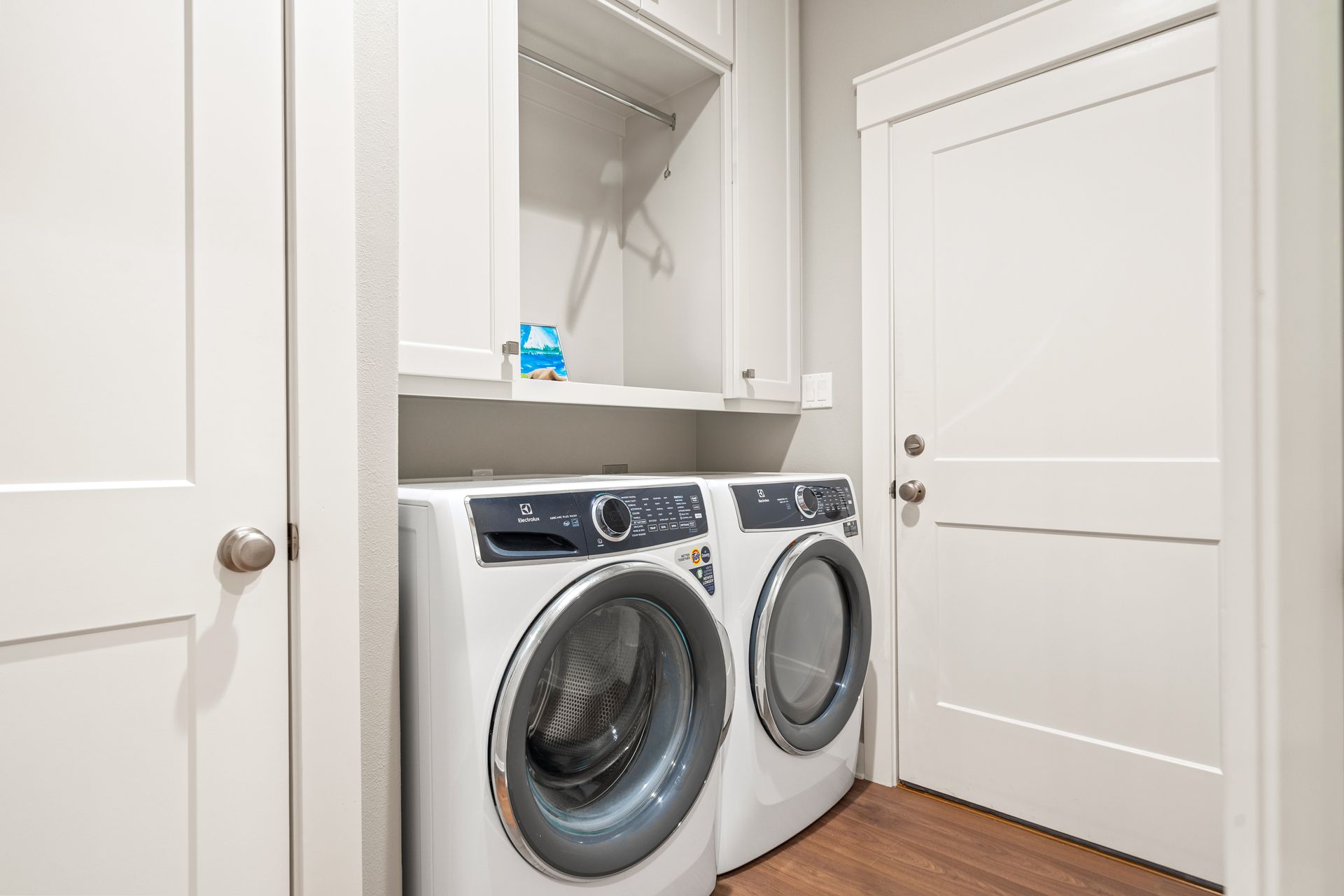 A laundry room with a washer and dryer stacked on top of each other.