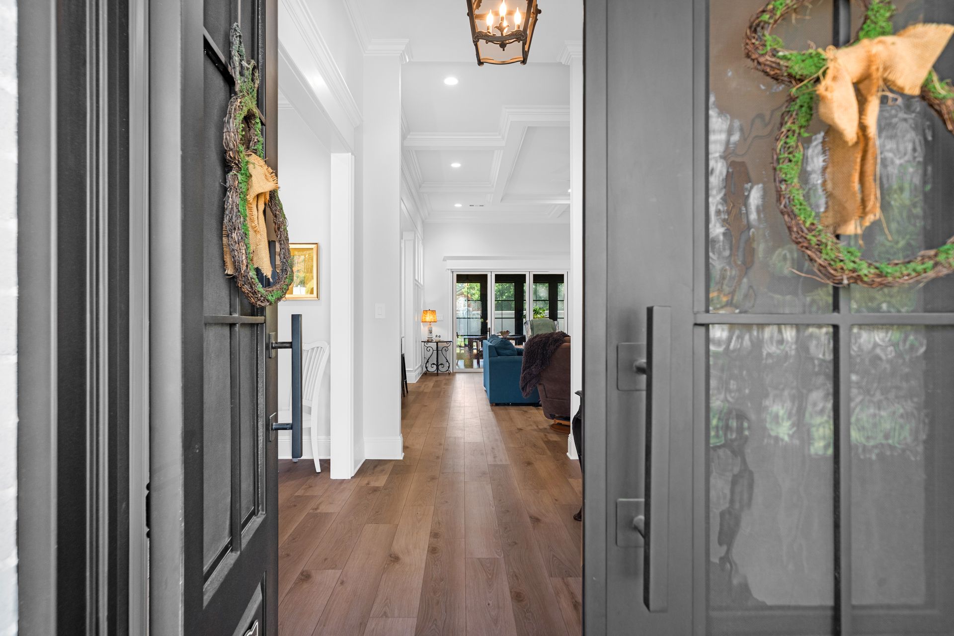 The front door of a house with a wreath hanging on it.