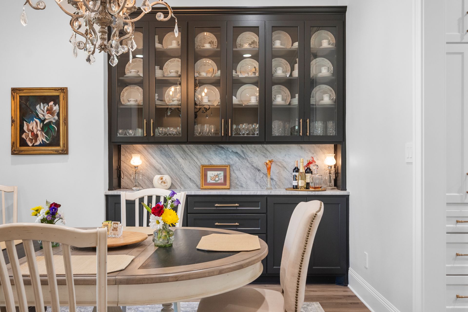 A dining room with a table and chairs and a chandelier.