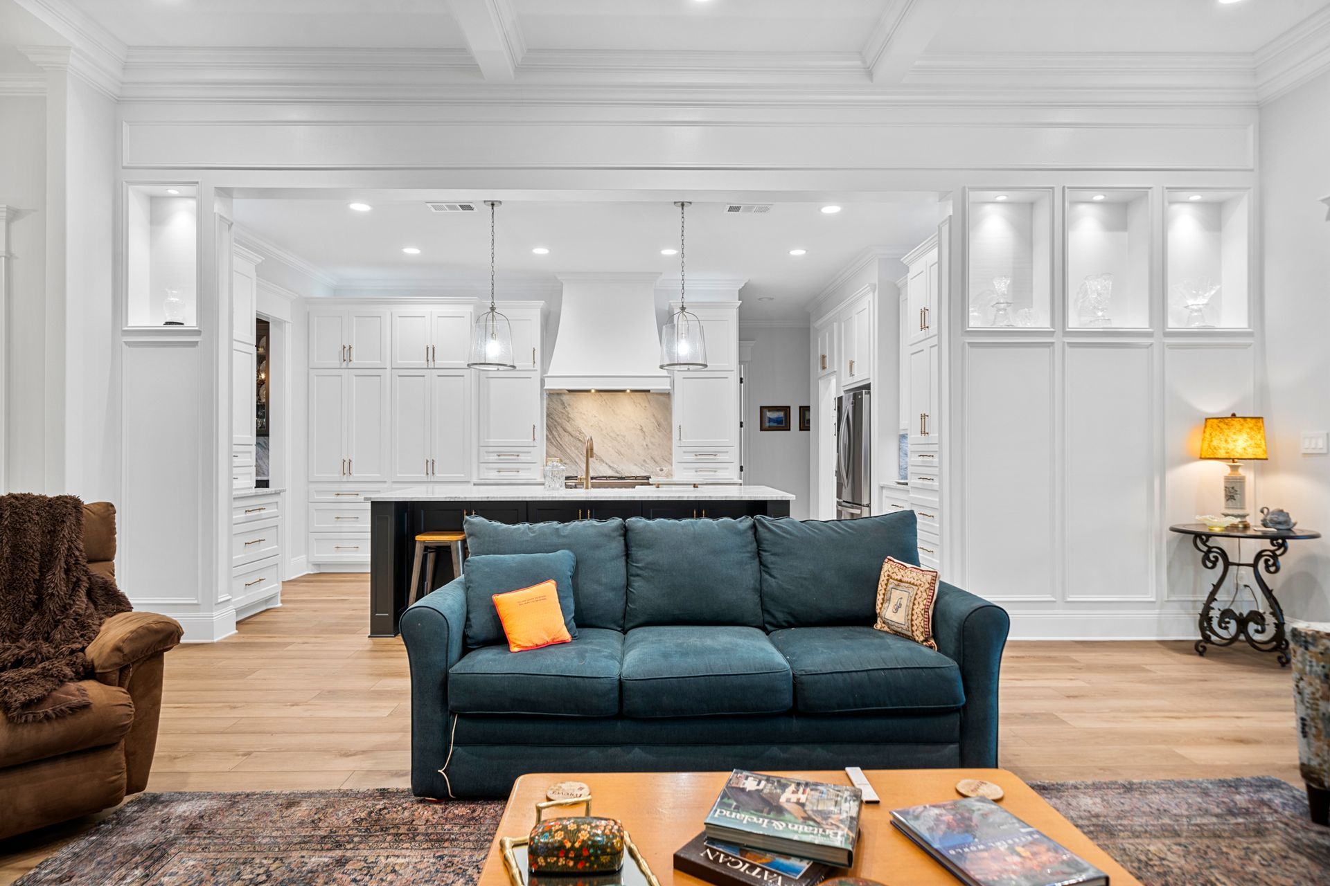 A living room with a blue couch and a coffee table.