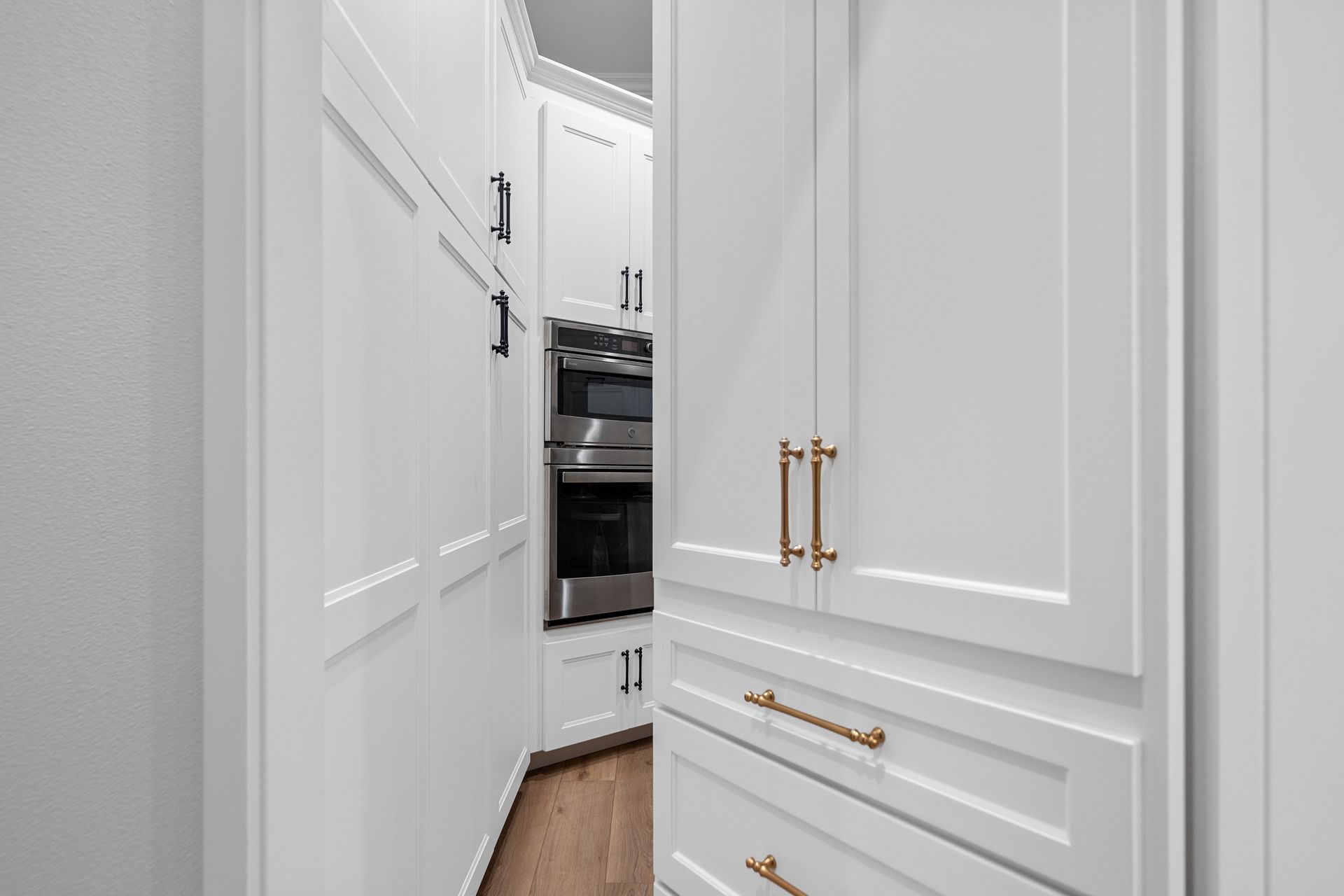A kitchen with white cabinets and stainless steel appliances.