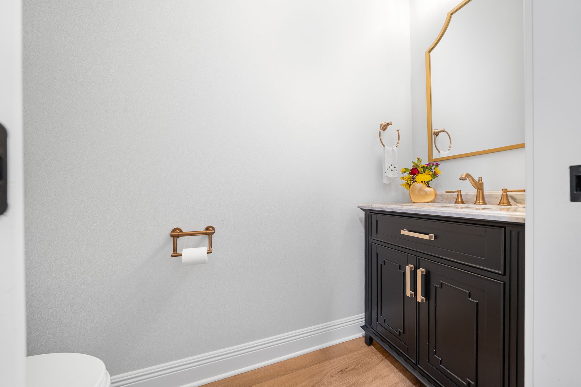 A bathroom with a sink , toilet and mirror.