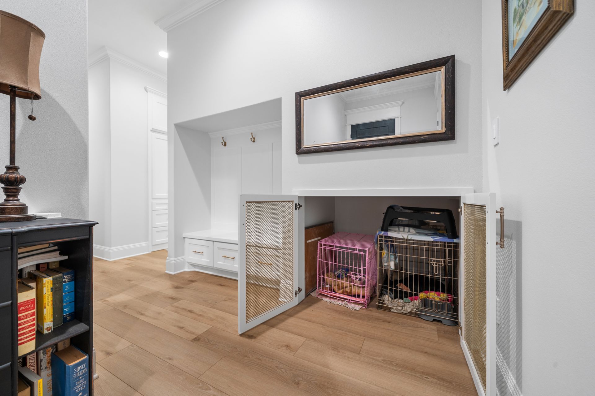 There is a dog cage in the corner of the room.