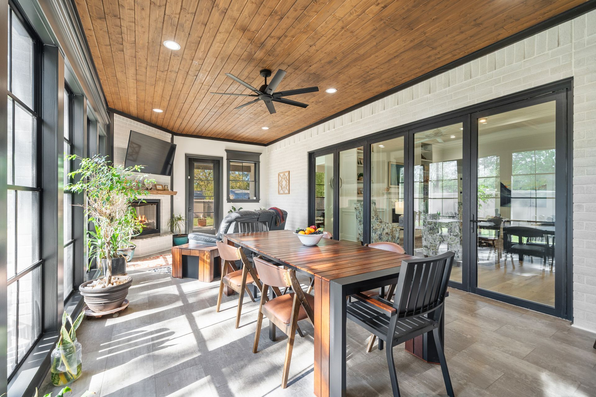 A dining room with a table and chairs and a ceiling fan.