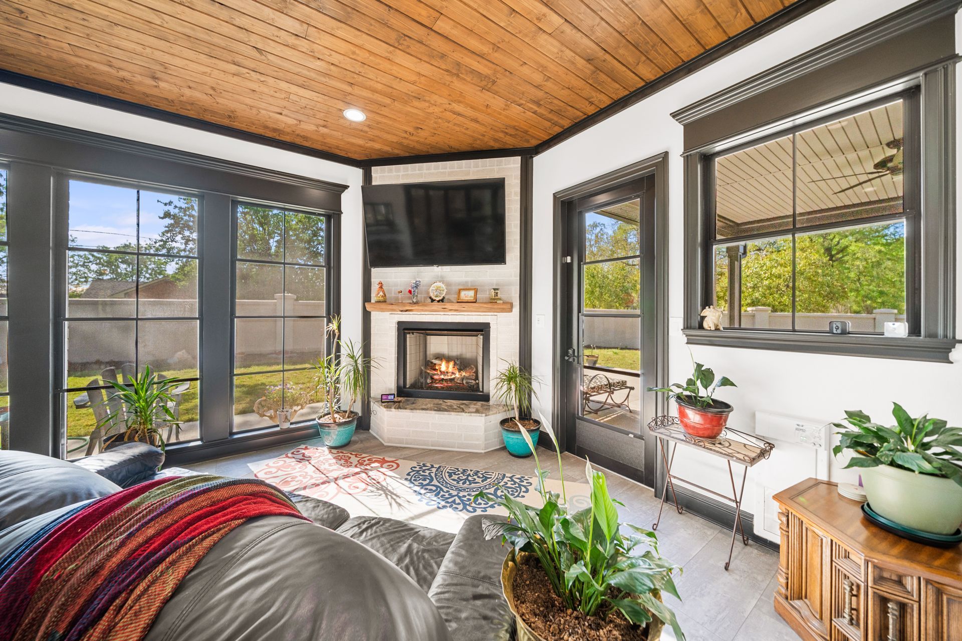 A living room with a fireplace and a flat screen tv.