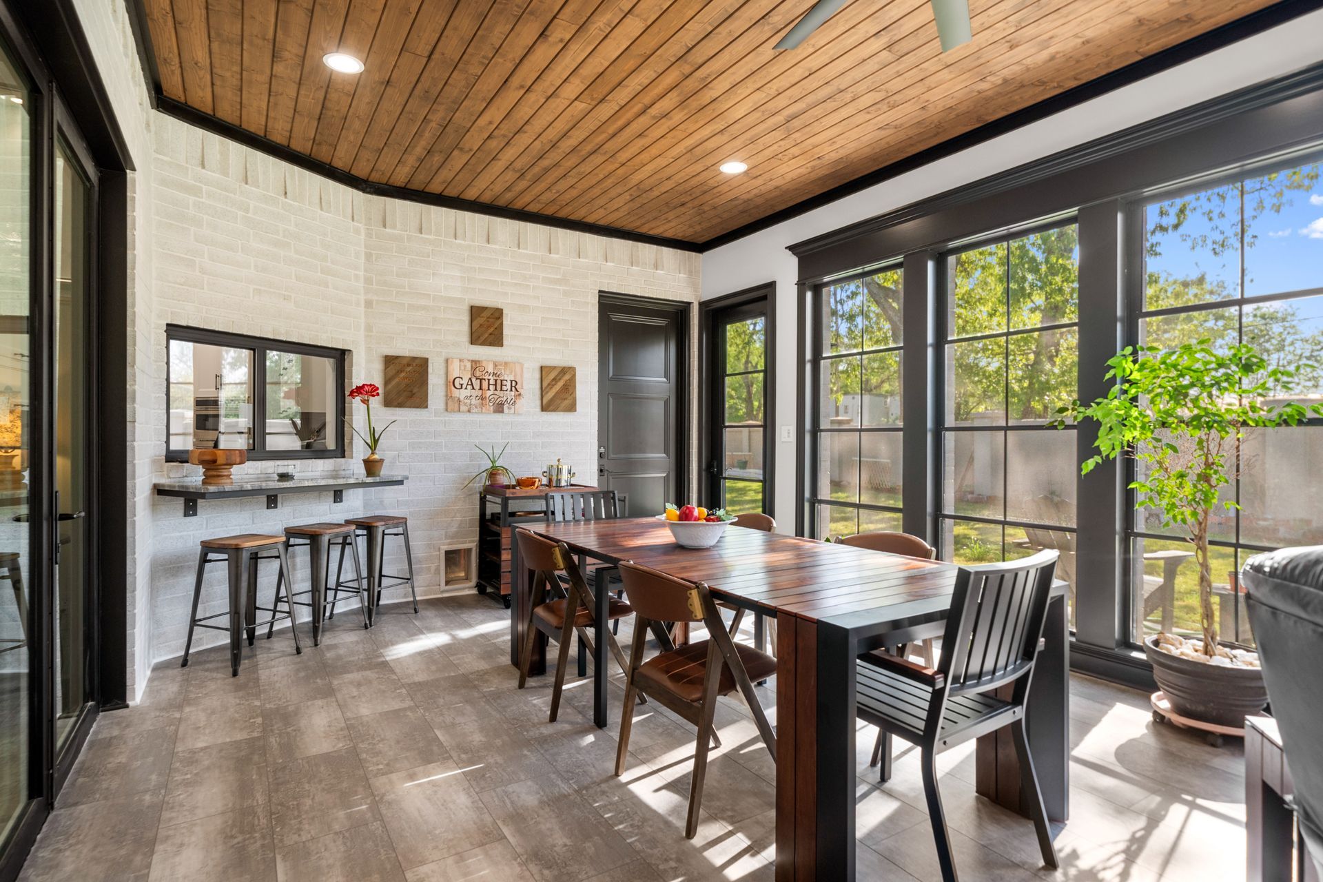 A dining room with a table and chairs and a ceiling fan.