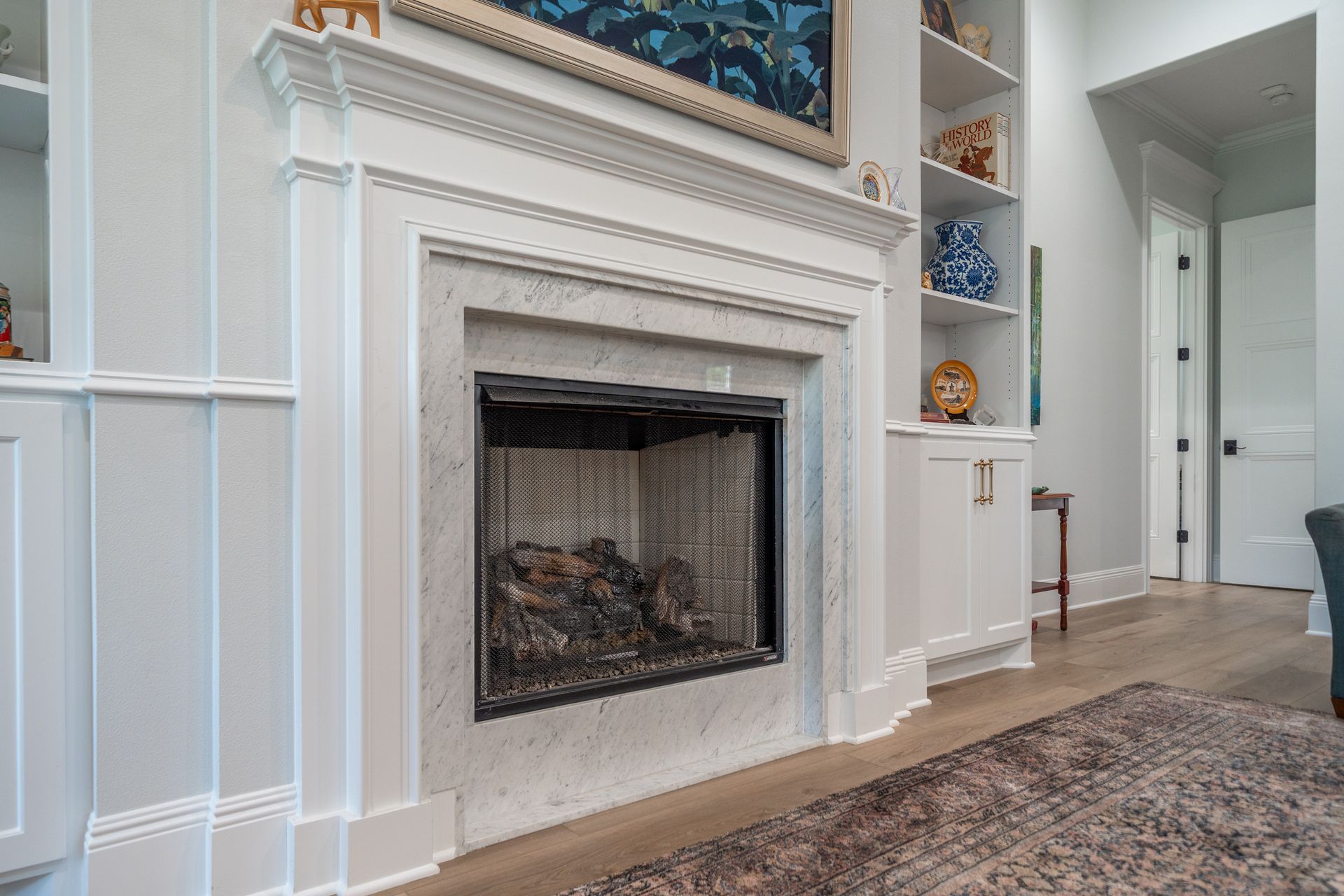 There is a fireplace in the middle of the living room.