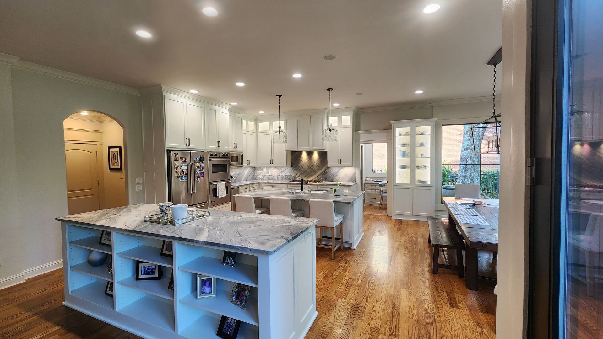 A large kitchen with a large island in the middle of it.