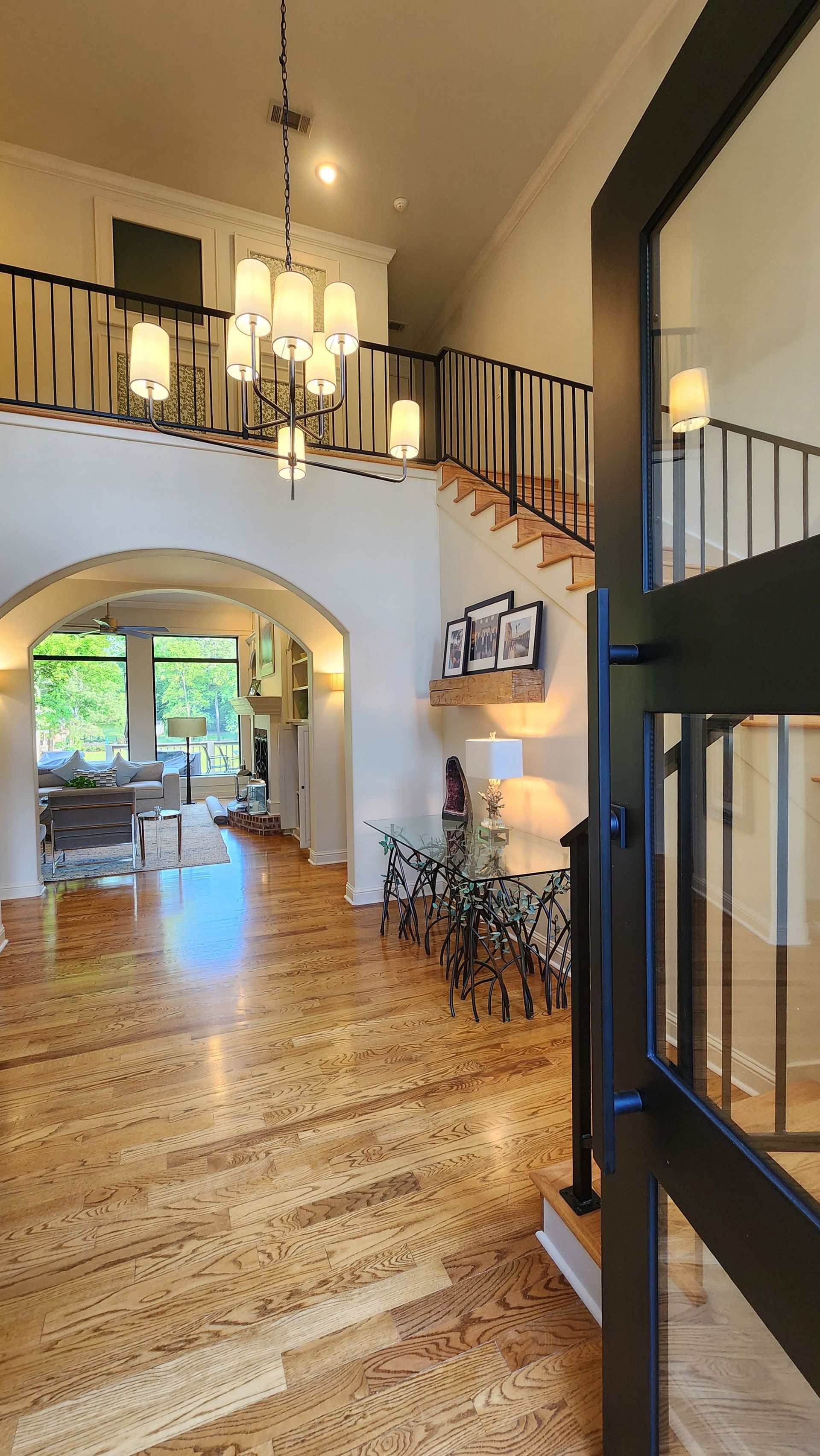 A large room with a staircase and a chandelier.
