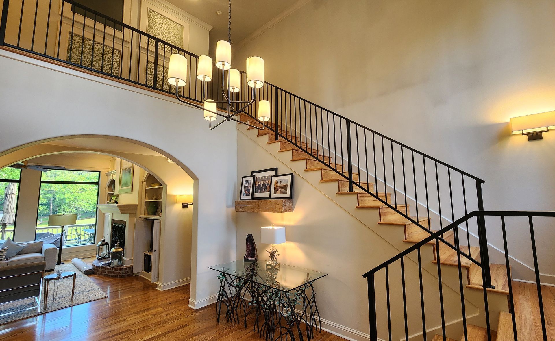 A staircase in a house with a wrought iron railing