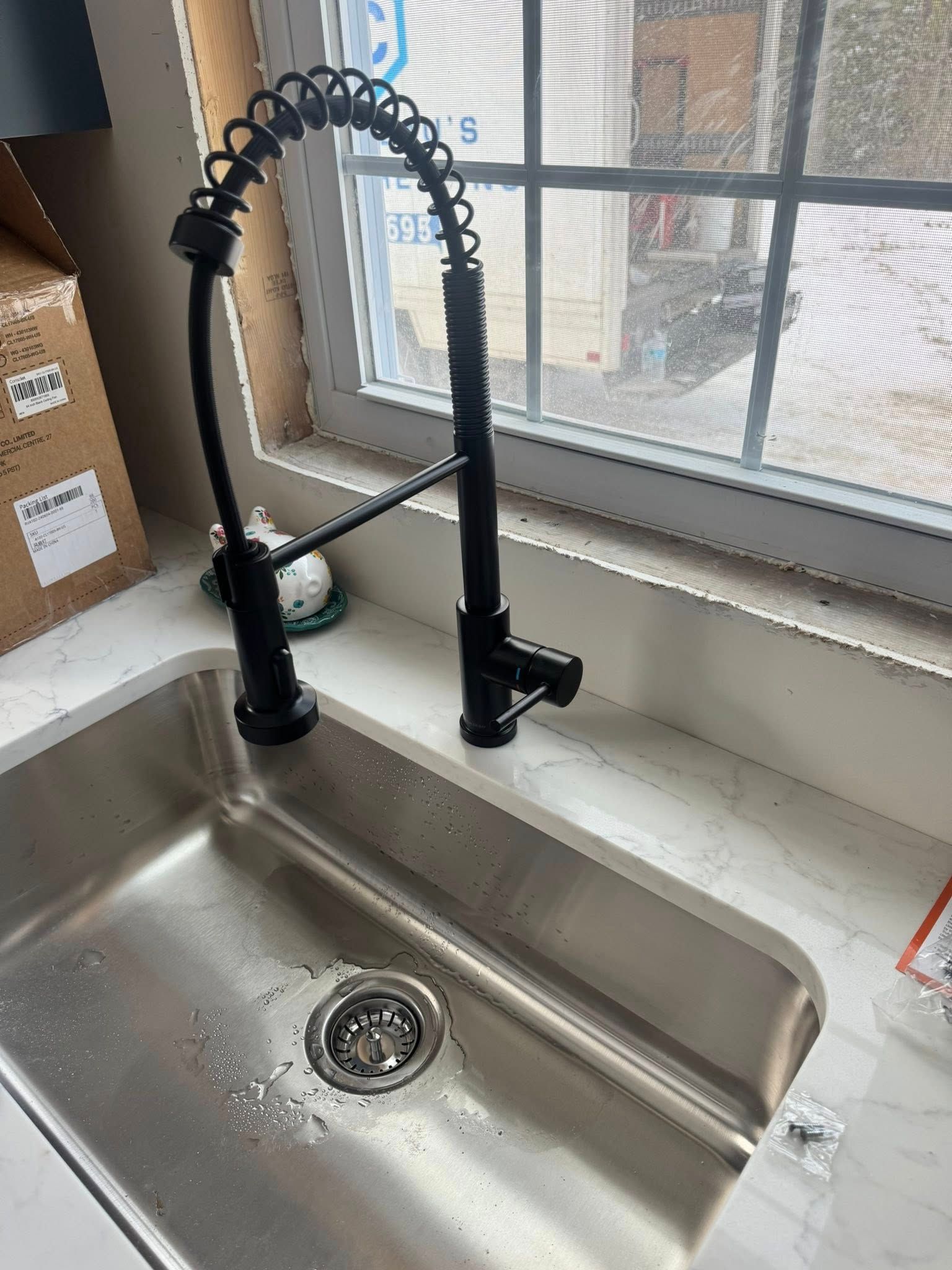 A person is pumping a hose into a septic tank.