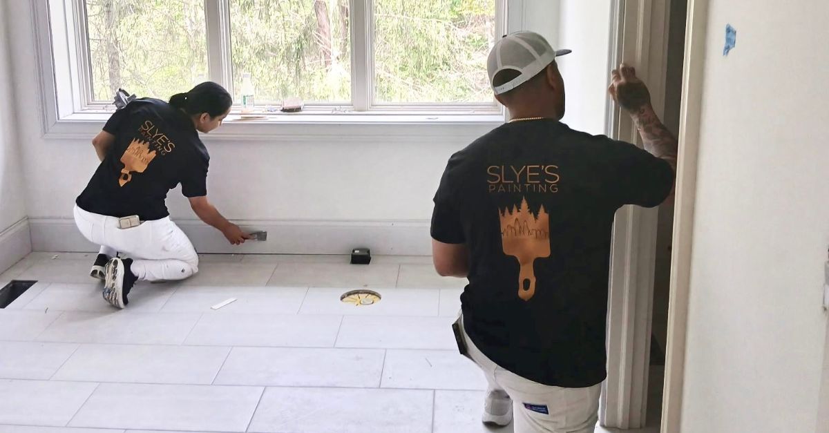A kitchen with a large island and a logo for slye 's painting