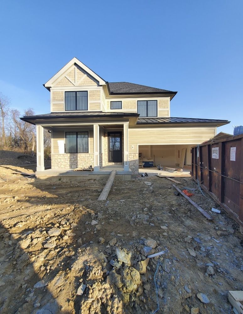 A house is being built in the middle of a dirt field.