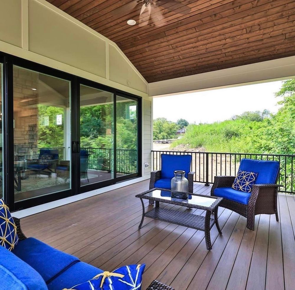 A balcony with blue chairs and a blue couch