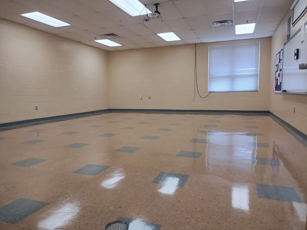 An empty room with a tiled floor and a window